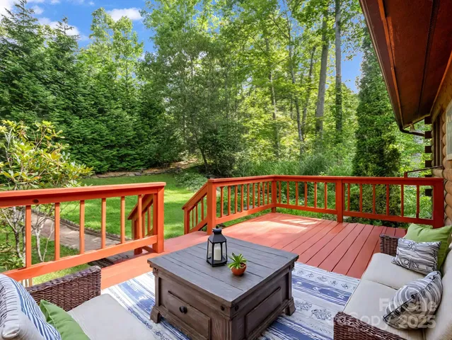 a balcony with wooden floor and a swing