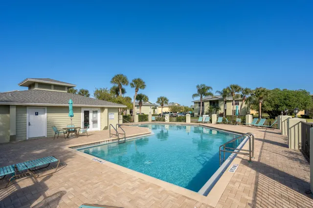 aerial view of a house with yard and large trees