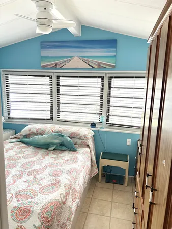 a bedroom with a bed and windows