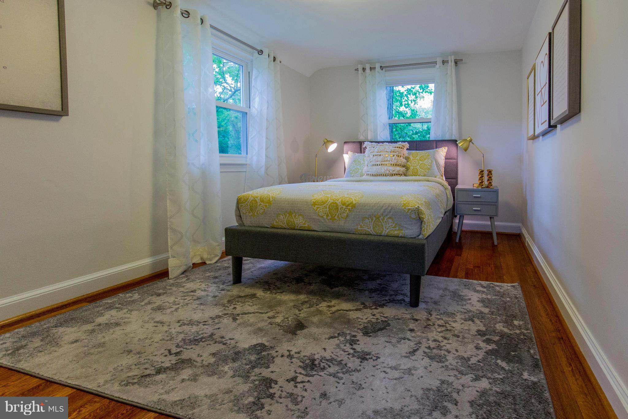 9010 Eton Road Silver Spring, MD 20901 - Photo 18 of 30 a bed sitting in a bedroom next to a window