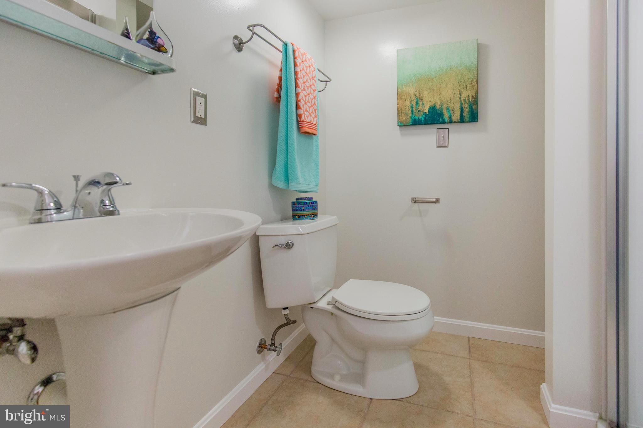9010 Eton Road Silver Spring, MD 20901 - Photo 28 of 30 a bathroom with a toilet sink and mirror