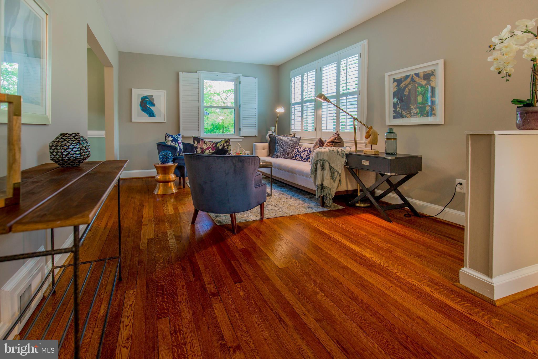 9010 Eton Road Silver Spring, MD 20901 - Photo 5 of 30 a living room filled with furniture and a wooden floor