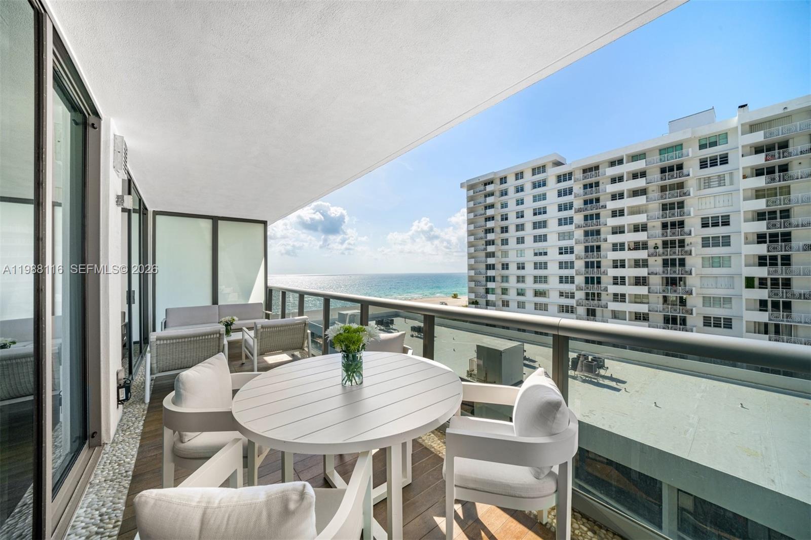 5875 Collins Avenue, Unit 906 Miami Beach, FL 33140 - Photo 11 of 20 a view of a dining room with furniture window and wooden floor