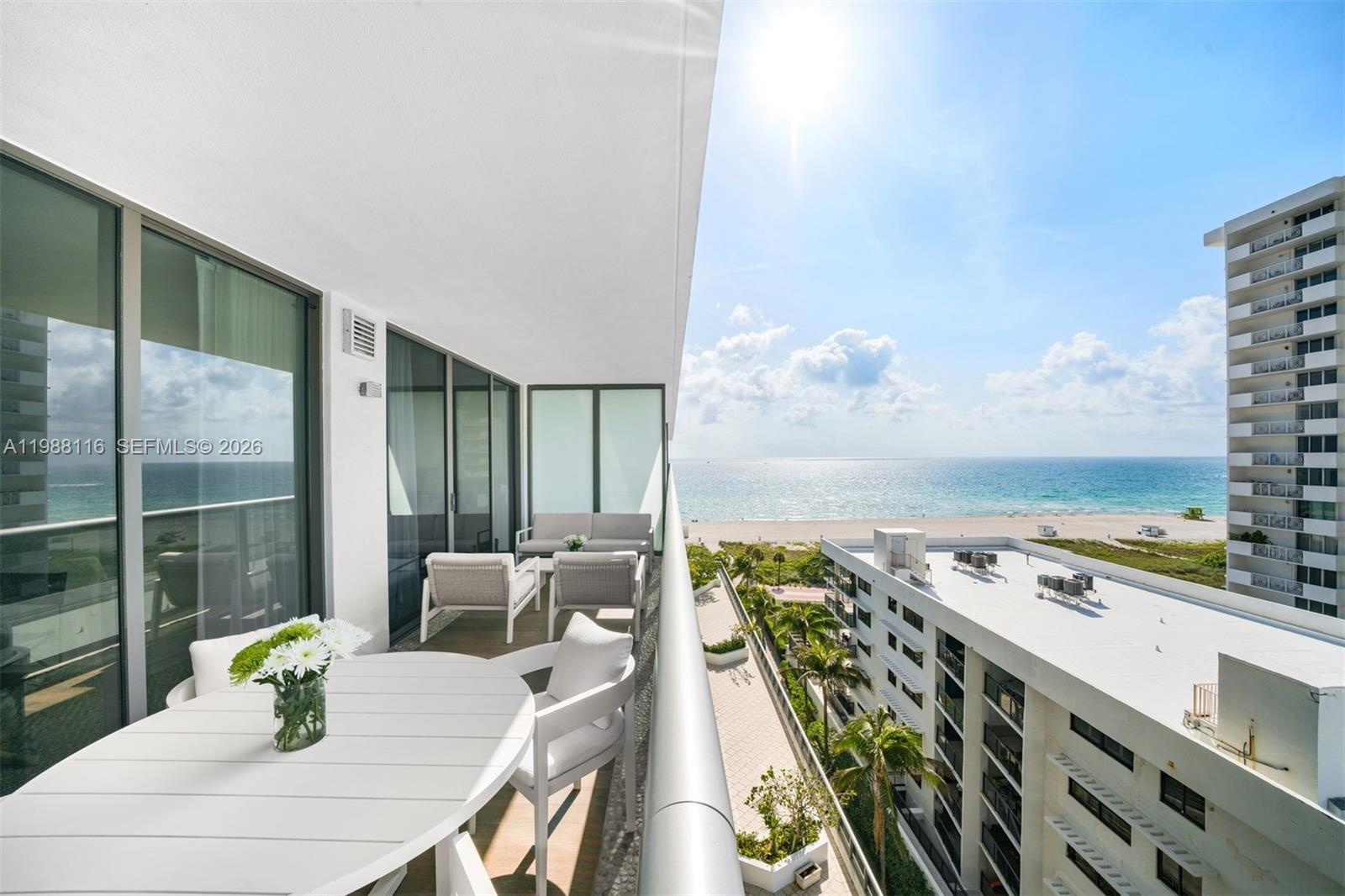 5875 Collins Avenue, Unit 906 Miami Beach, FL 33140 - Photo 13 of 20 a view of a balcony with dining table and chairs
