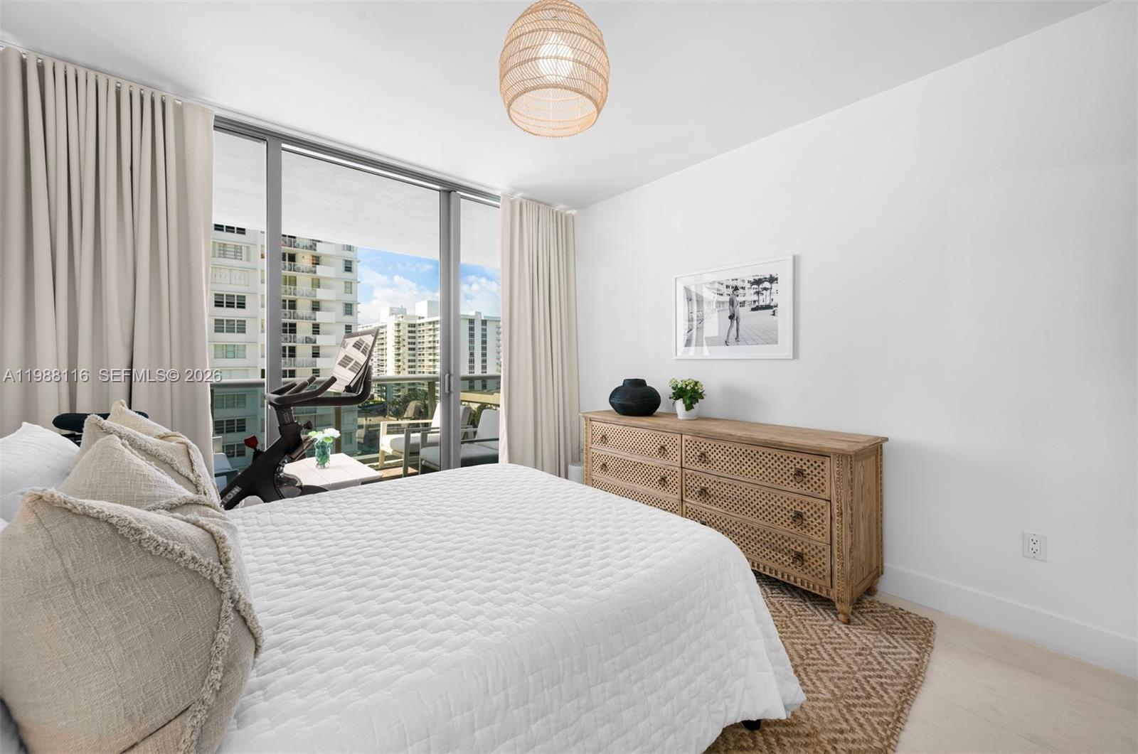 5875 Collins Avenue, Unit 906 Miami Beach, FL 33140 - Photo 15 of 20 a bedroom with a bed and window