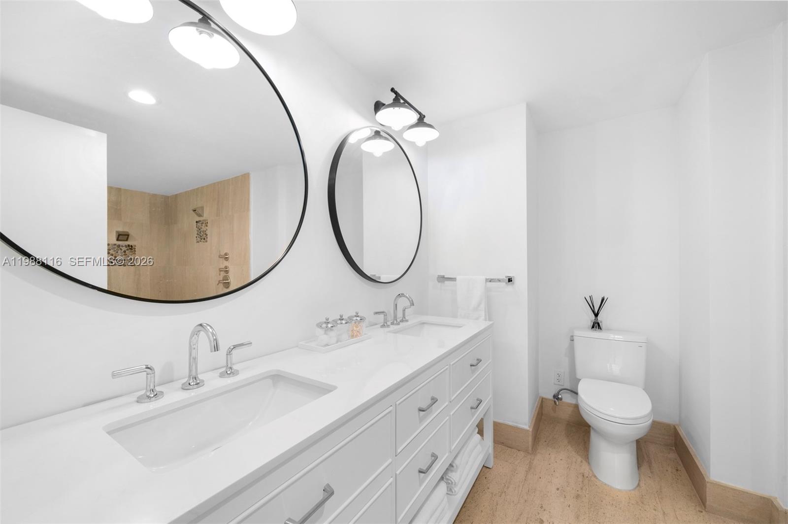 5875 Collins Avenue, Unit 906 Miami Beach, FL 33140 - Photo 16 of 20 a bathroom with a double vanity sink and a mirror