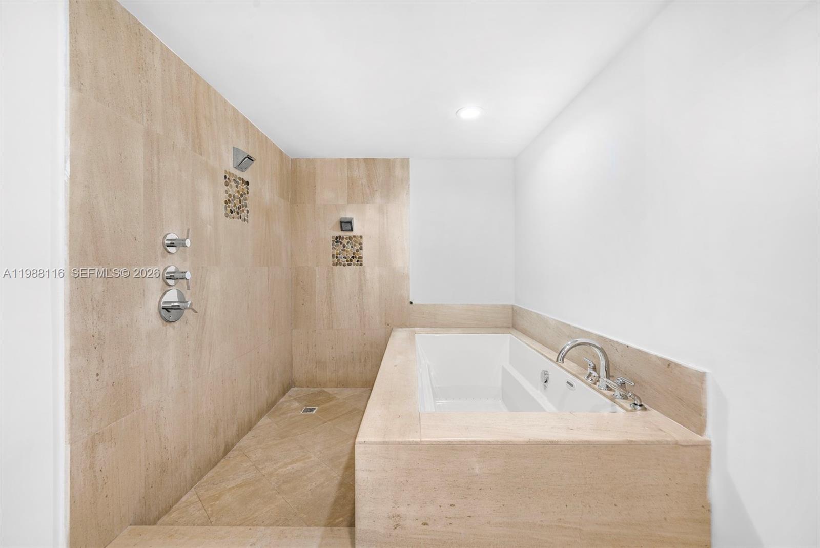 5875 Collins Avenue, Unit 906 Miami Beach, FL 33140 - Photo 18 of 20 a bathroom with a sink and shower