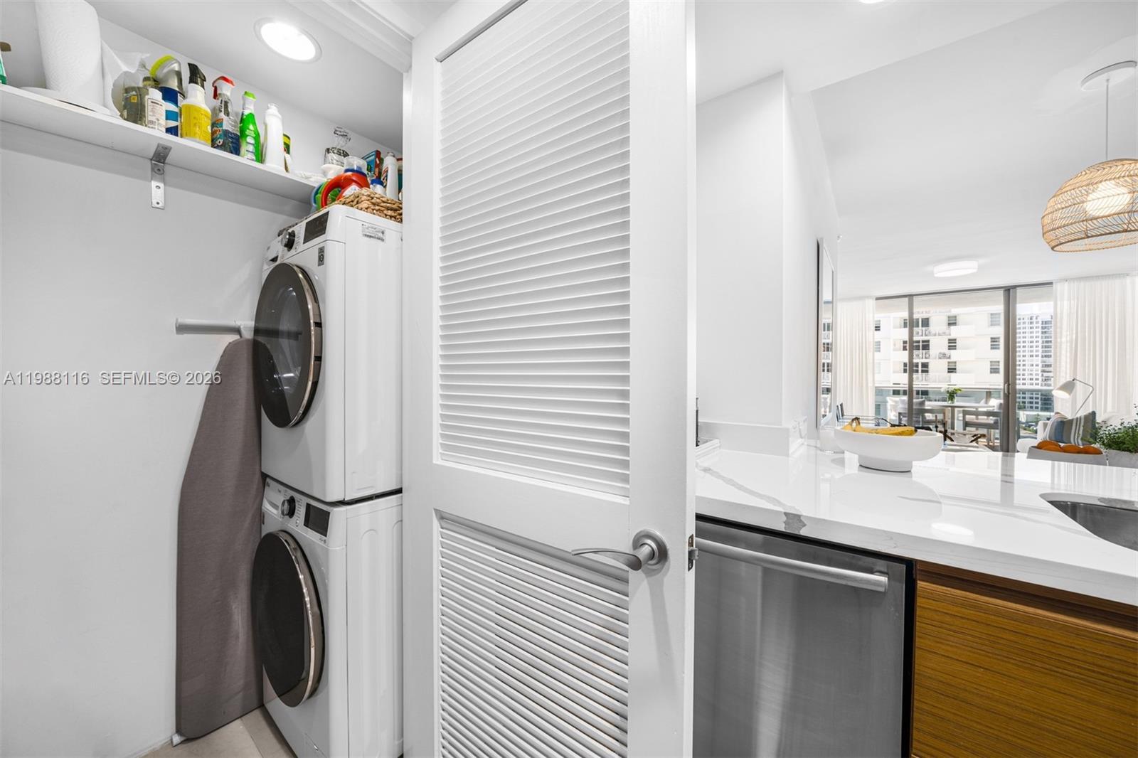 5875 Collins Avenue, Unit 906 Miami Beach, FL 33140 - Photo 20 of 20 a storage room with washer and dryer