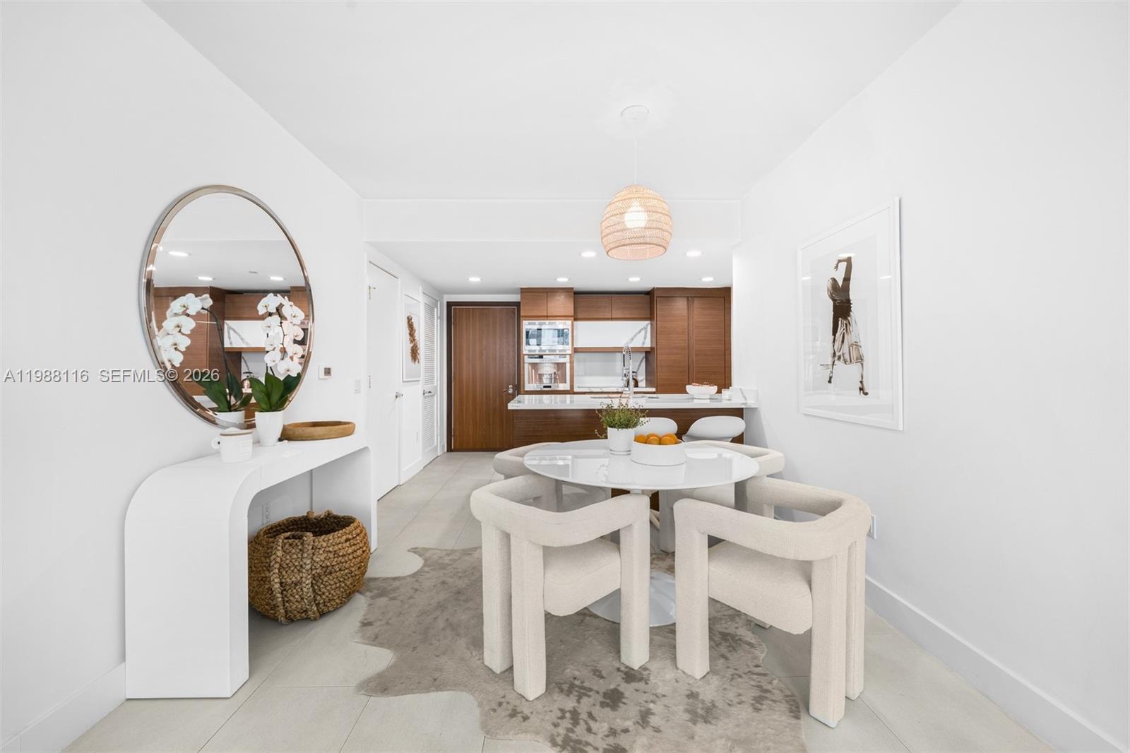 5875 Collins Avenue, Unit 906 Miami Beach, FL 33140 - Photo 2 of 20 a view of a dining room with furniture and a chandelier