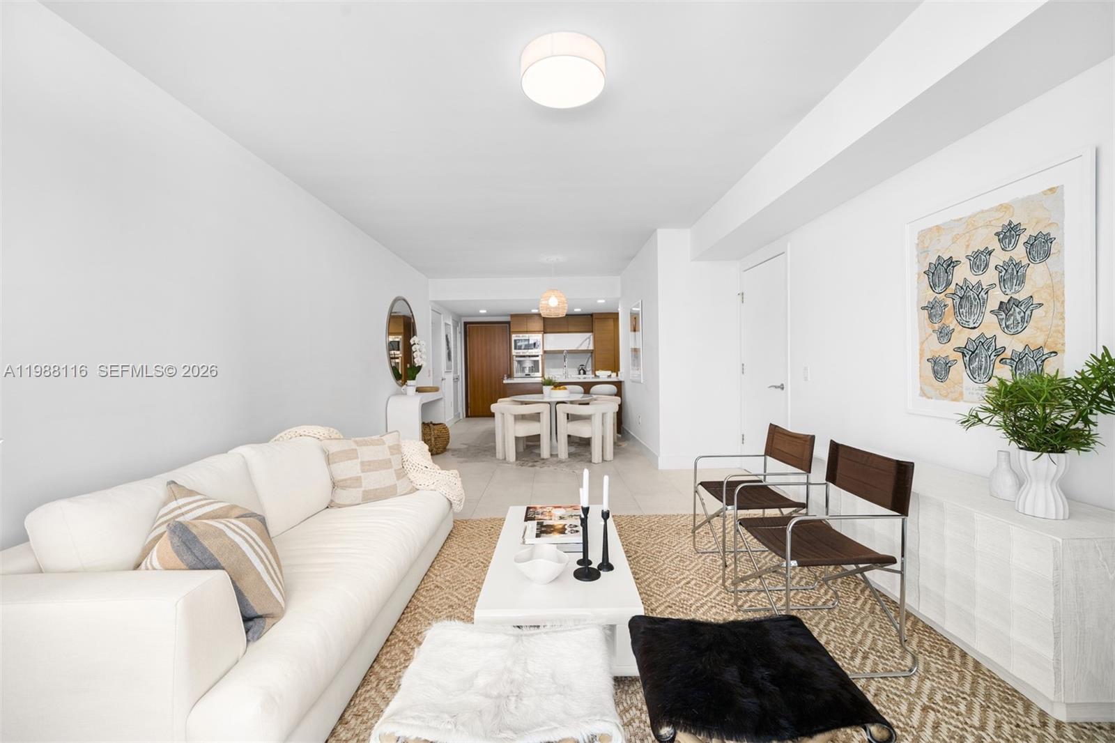 5875 Collins Avenue, Unit 906 Miami Beach, FL 33140 - Photo 6 of 20 a living room with furniture and a table