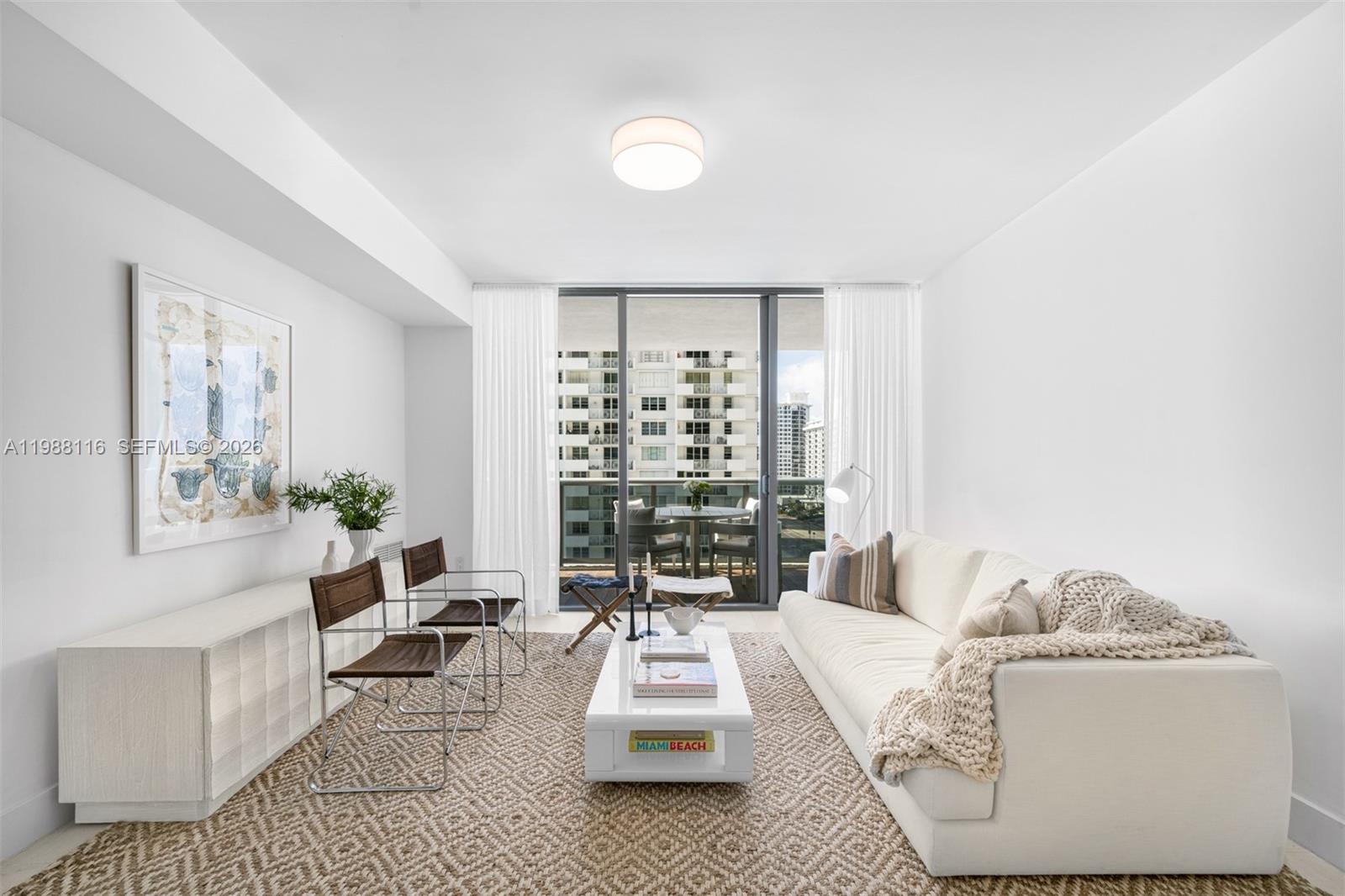 5875 Collins Avenue, Unit 906 Miami Beach, FL 33140 - Photo 7 of 20 a living room with furniture and a large window