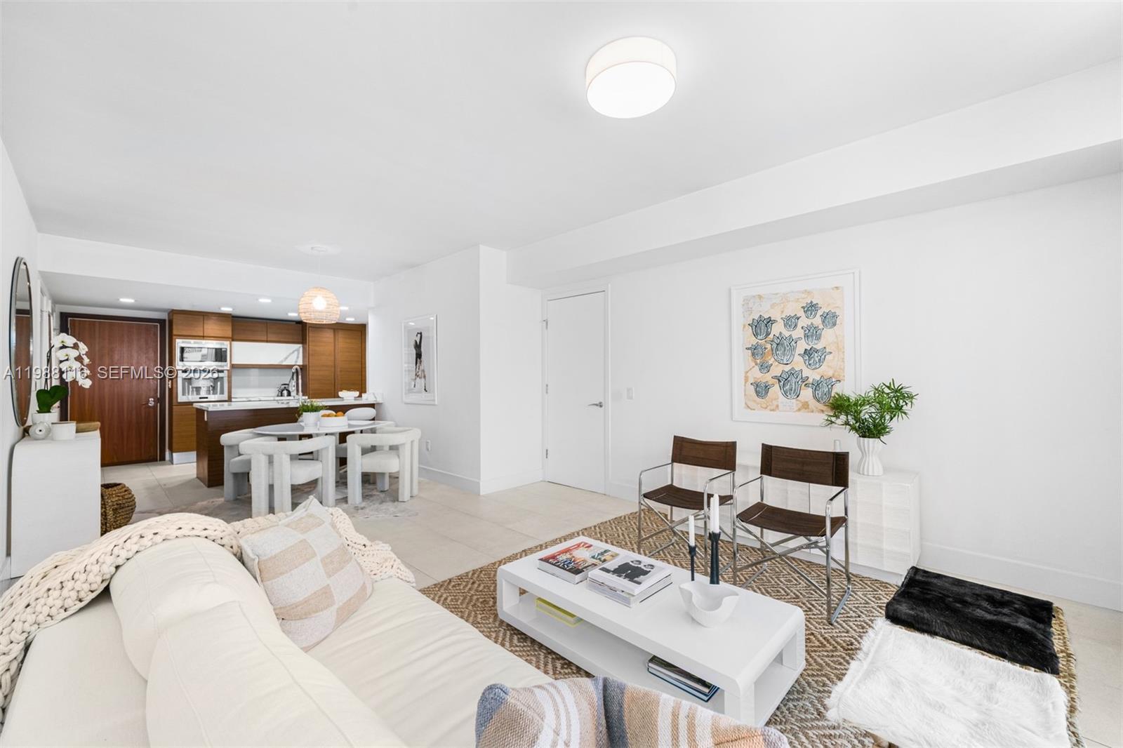5875 Collins Avenue, Unit 906 Miami Beach, FL 33140 - Photo 8 of 20 a living room with furniture and a flat screen tv