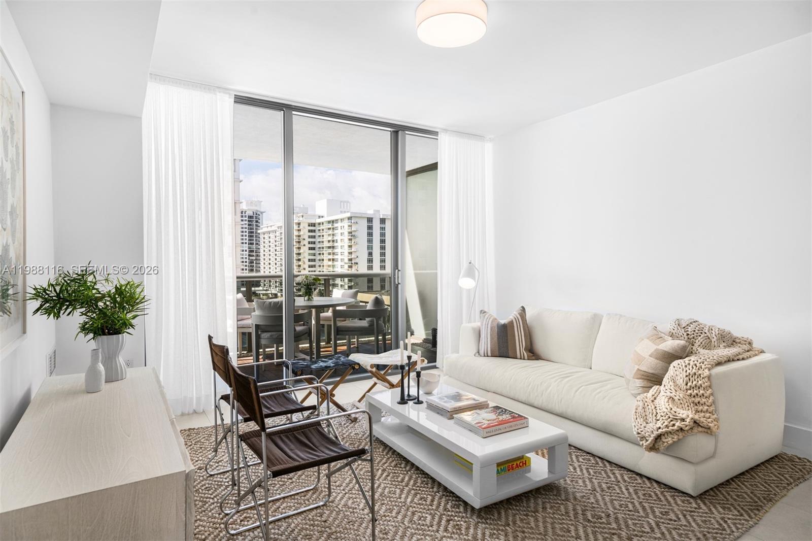 5875 Collins Avenue, Unit 906 Miami Beach, FL 33140 - Photo 9 of 20 a living room with furniture and floor to ceiling windows