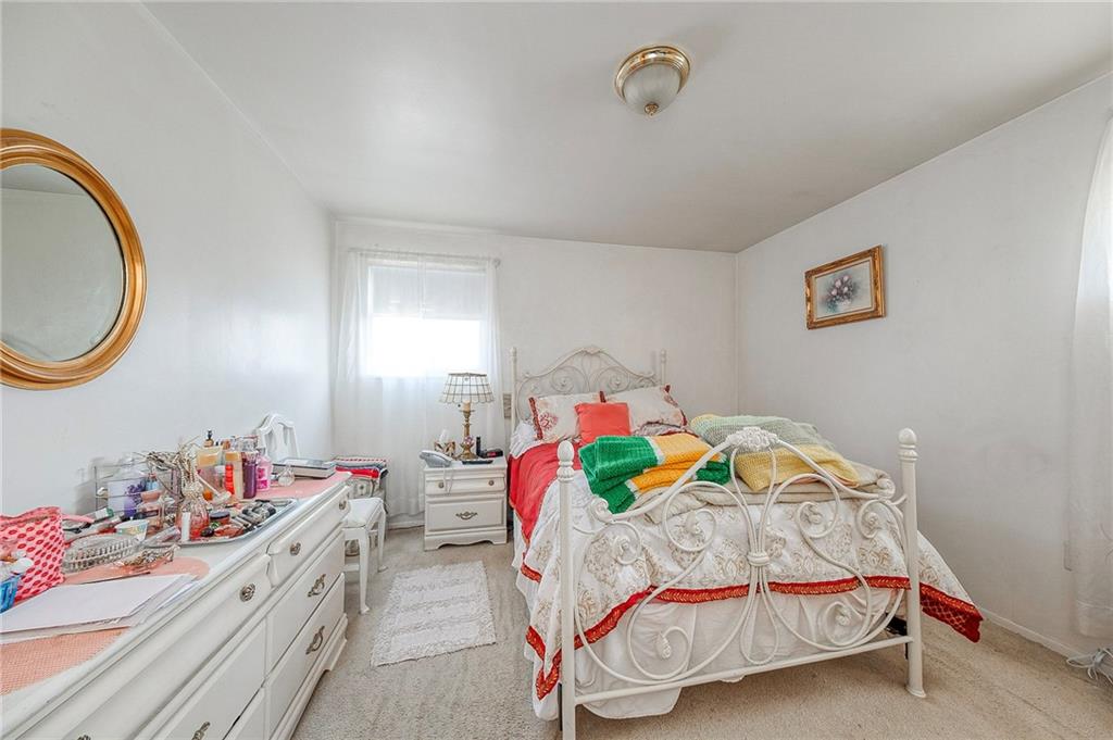 923 Locust Street Coraopolis, PA 15108 - Photo 12 of 27 a bedroom with bed and a table