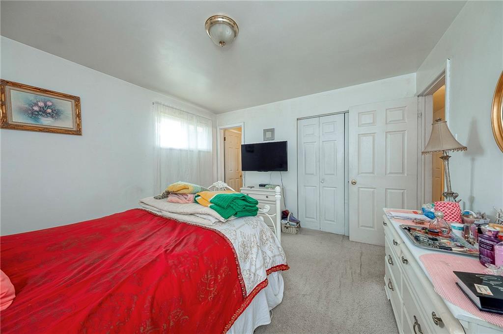 923 Locust Street Coraopolis, PA 15108 - Photo 13 of 27 a bedroom with a bed and a flat screen tv