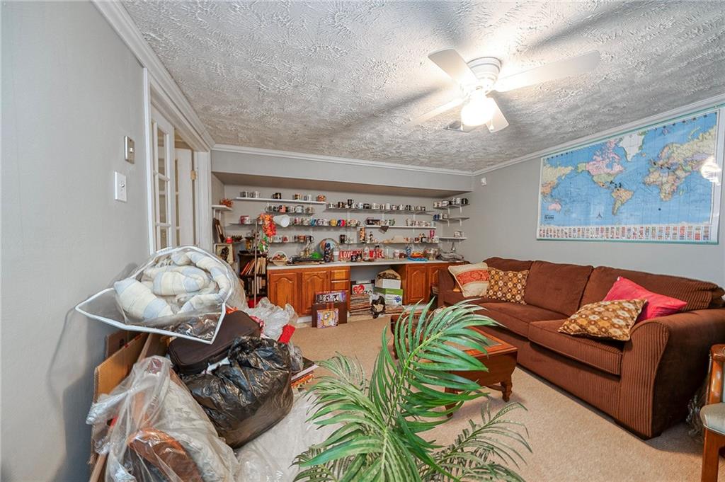 923 Locust Street Coraopolis, PA 15108 - Photo 18 of 27 a living room with furniture and a chandelier