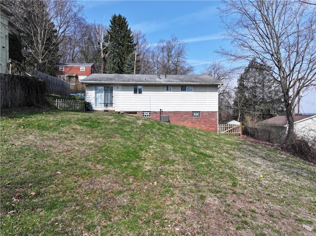 923 Locust Street Coraopolis, PA 15108 - Photo 22 of 27 a front view of a house with a yard and a garage