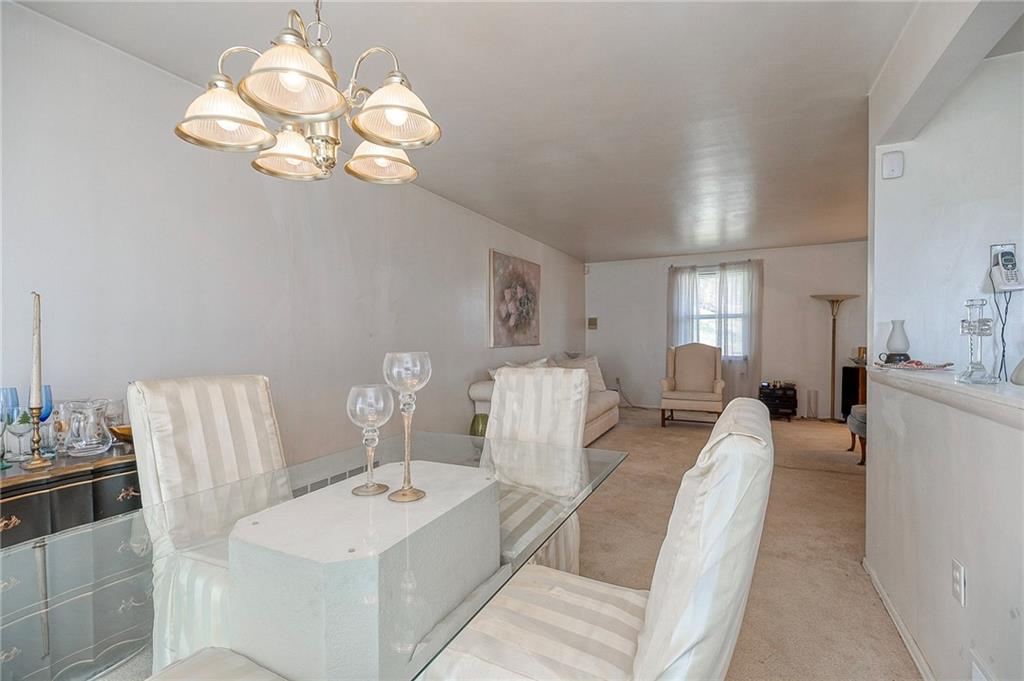 923 Locust Street Coraopolis, PA 15108 - Photo 5 of 27 a living room with furniture a chandelier and a mirror