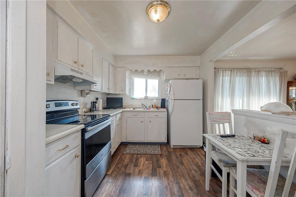 923 Locust Street Coraopolis, PA 15108 - Photo 7 of 27 a kitchen with a white stove top oven and refrigerator