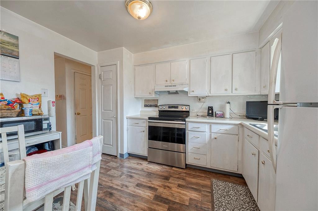 923 Locust Street Coraopolis, PA 15108 - Photo 9 of 27 a kitchen with cabinets stainless steel appliances and a window