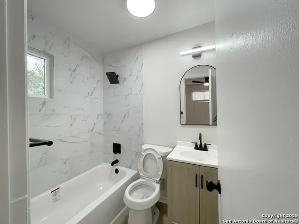 a bathroom with a toilet sink and shower