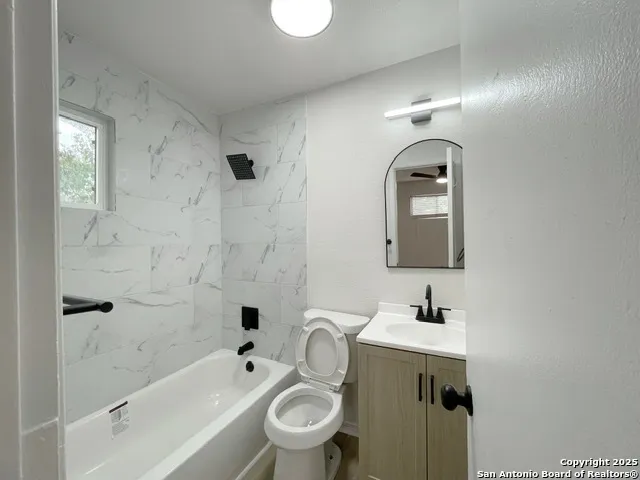 a bathroom with a toilet sink and shower