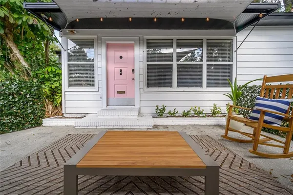 a swimming pool with barbeque oven table and chairs