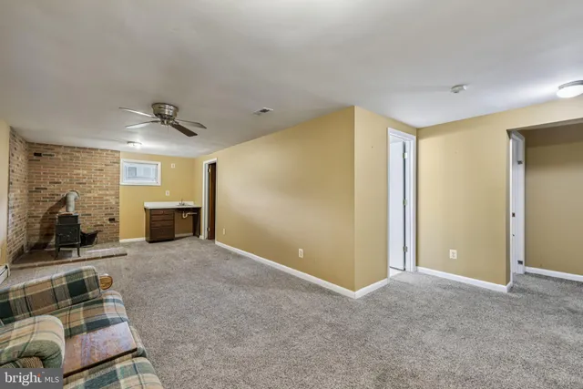 a view of a livingroom with furniture and a ceiling fan