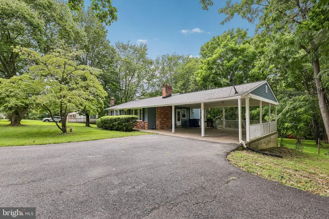 a view of a house with a yard and tree