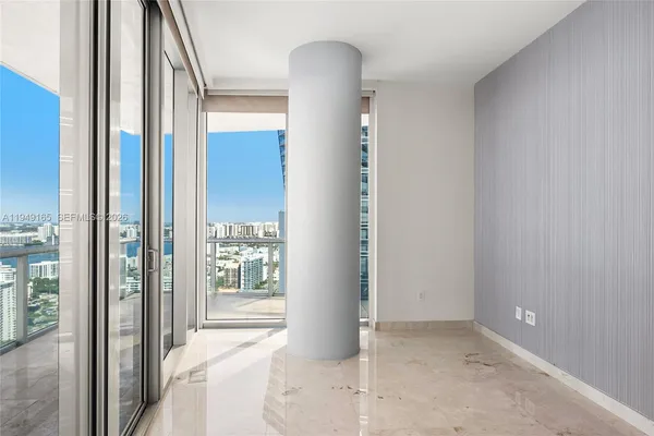 a view of an empty room and floor to ceiling window