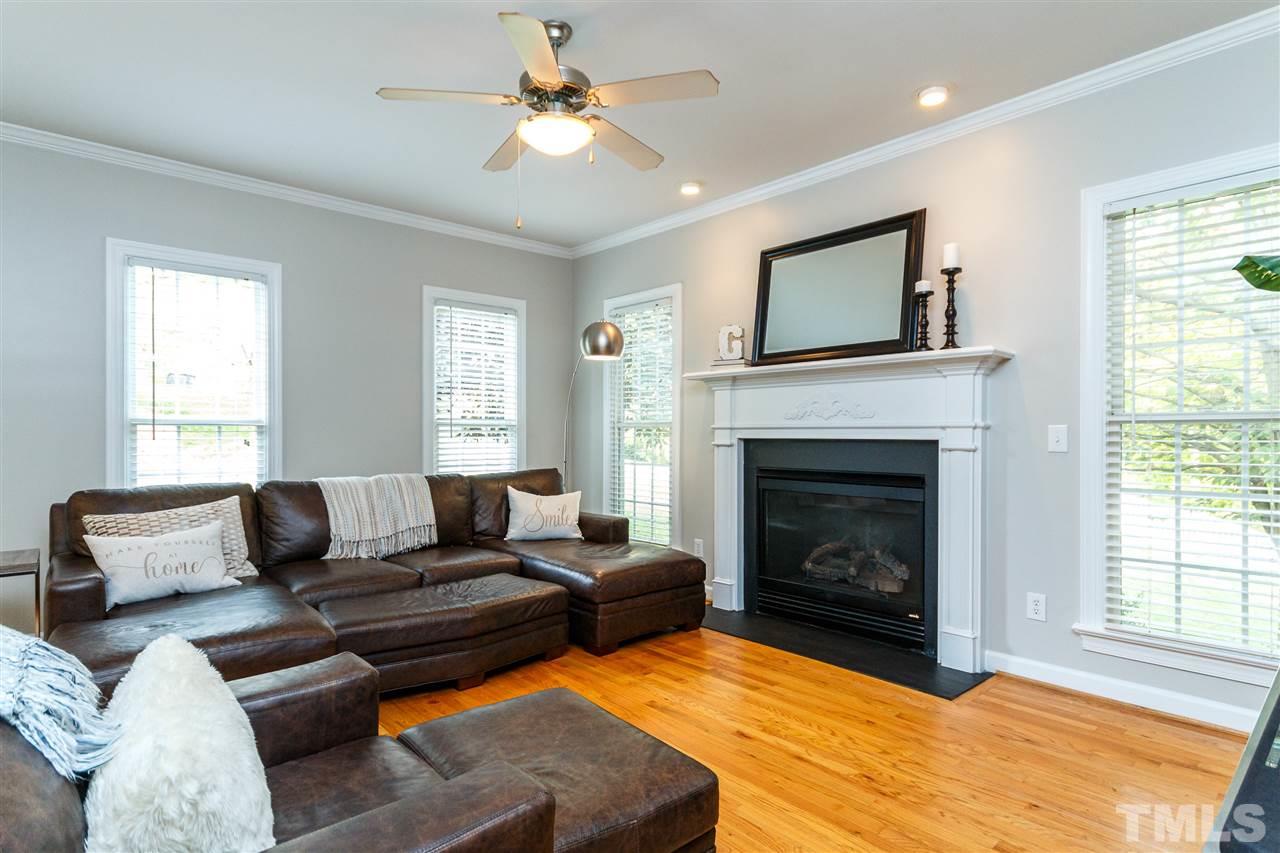 2936 Sunnystone Way Raleigh, NC 27613 - Photo 11 of 29 a living room with furniture and a fireplace