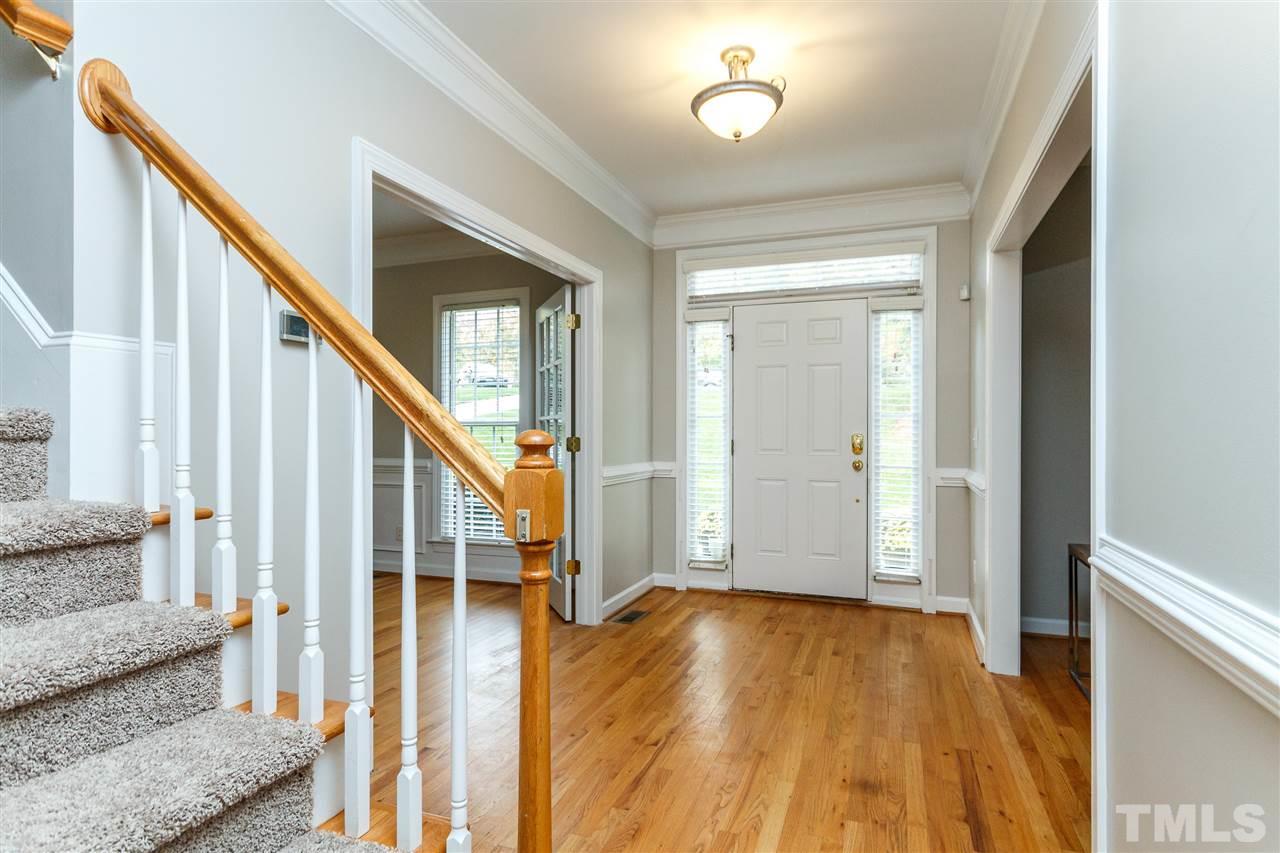 2936 Sunnystone Way Raleigh, NC 27613 - Photo 12 of 29 a view of an entryway with wooden floor and staircase