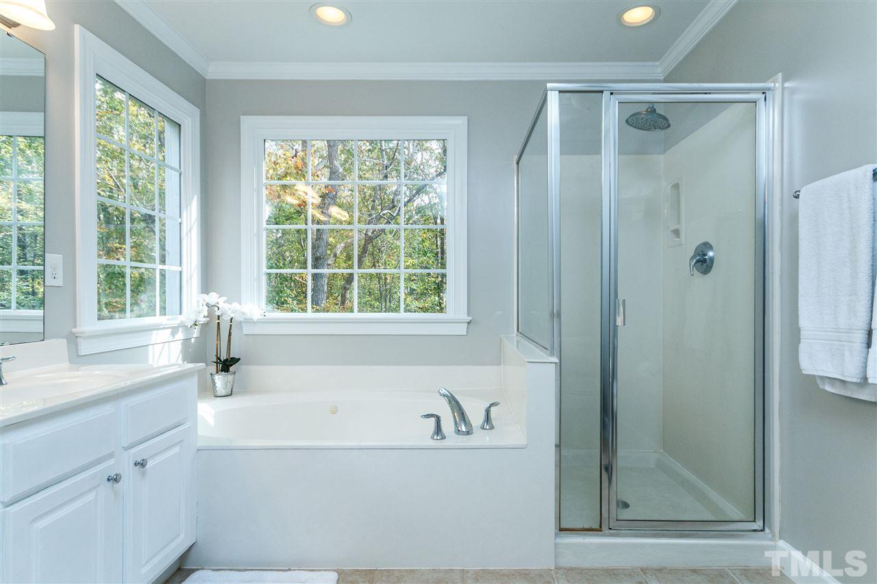 2936 Sunnystone Way Raleigh, NC 27613 - Photo 16 of 29 a bathroom with a bathtub and a sink