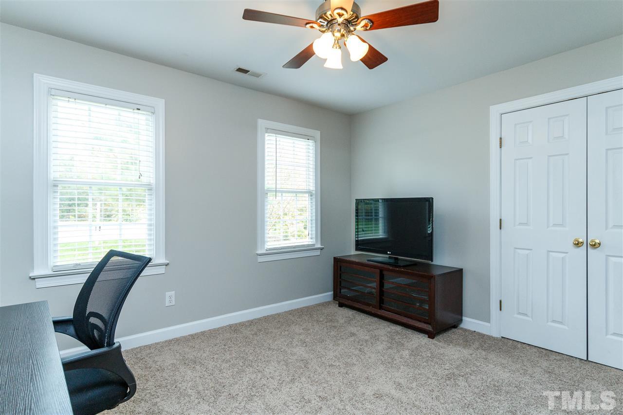 2936 Sunnystone Way Raleigh, NC 27613 - Photo 17 of 29 a living room with furniture and a flat screen tv