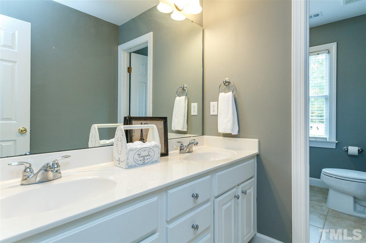 2936 Sunnystone Way Raleigh, NC 27613 - Photo 18 of 29 a bathroom with a double vanity sink and a mirror