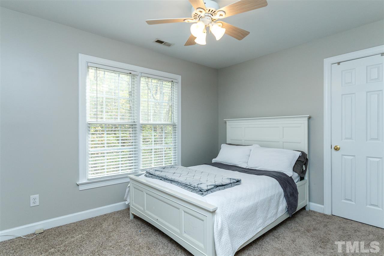 2936 Sunnystone Way Raleigh, NC 27613 - Photo 19 of 29 a bed sitting in a bedroom next to a window