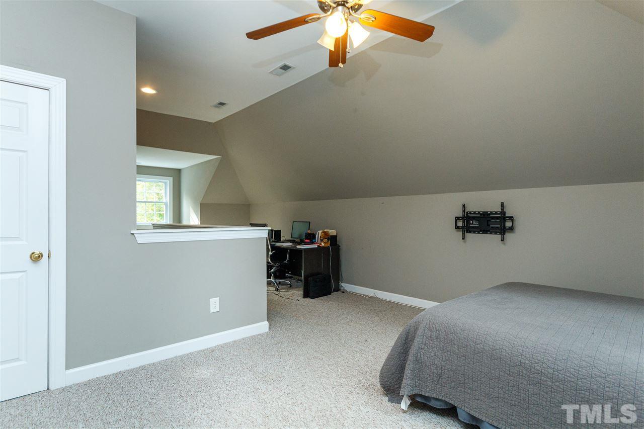 2936 Sunnystone Way Raleigh, NC 27613 - Photo 22 of 29 a room with a window and a ceiling fan