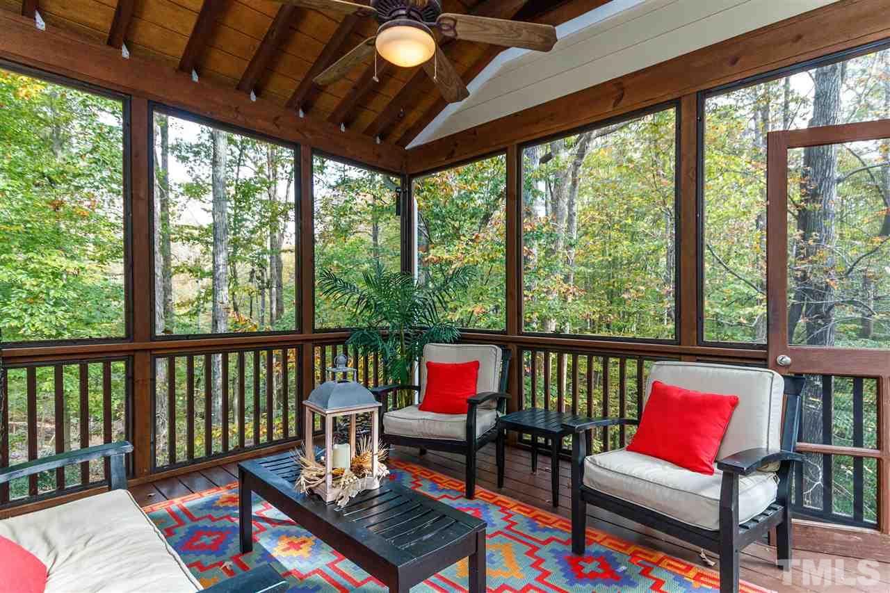 2936 Sunnystone Way Raleigh, NC 27613 - Photo 23 of 29 a living room with furniture and a floor to ceiling window