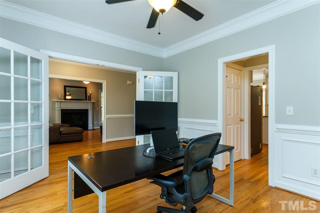 2936 Sunnystone Way Raleigh, NC 27613 - Photo 9 of 29 a view of a workspace with furniture and a potted plant
