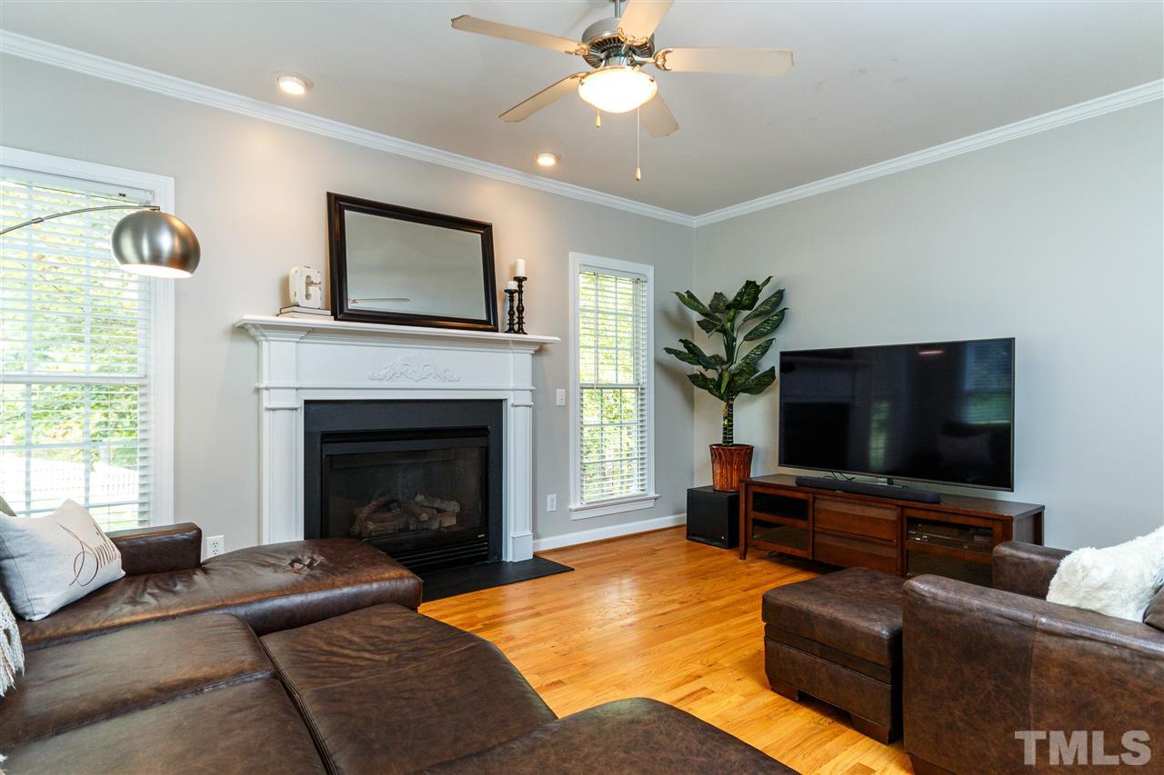 2936 Sunnystone Way Raleigh, NC 27613 - Photo 10 of 29 a living room with furniture and a fireplace