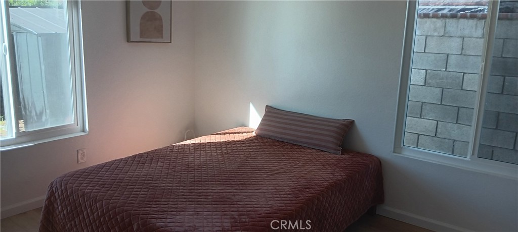 1022 Ruby Drive Perris, CA 92571 - Photo 16 of 27 a bed sitting in a bedroom next to a window