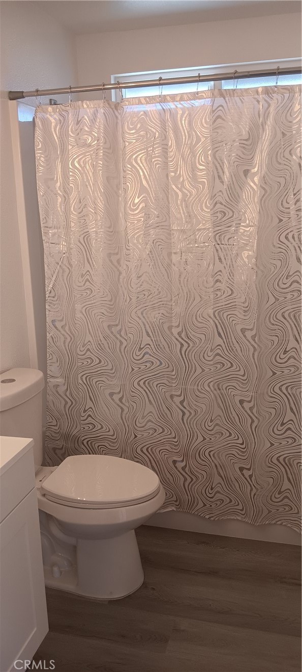 1022 Ruby Drive Perris, CA 92571 - Photo 20 of 27 a white toilet sitting next to a shower curtain