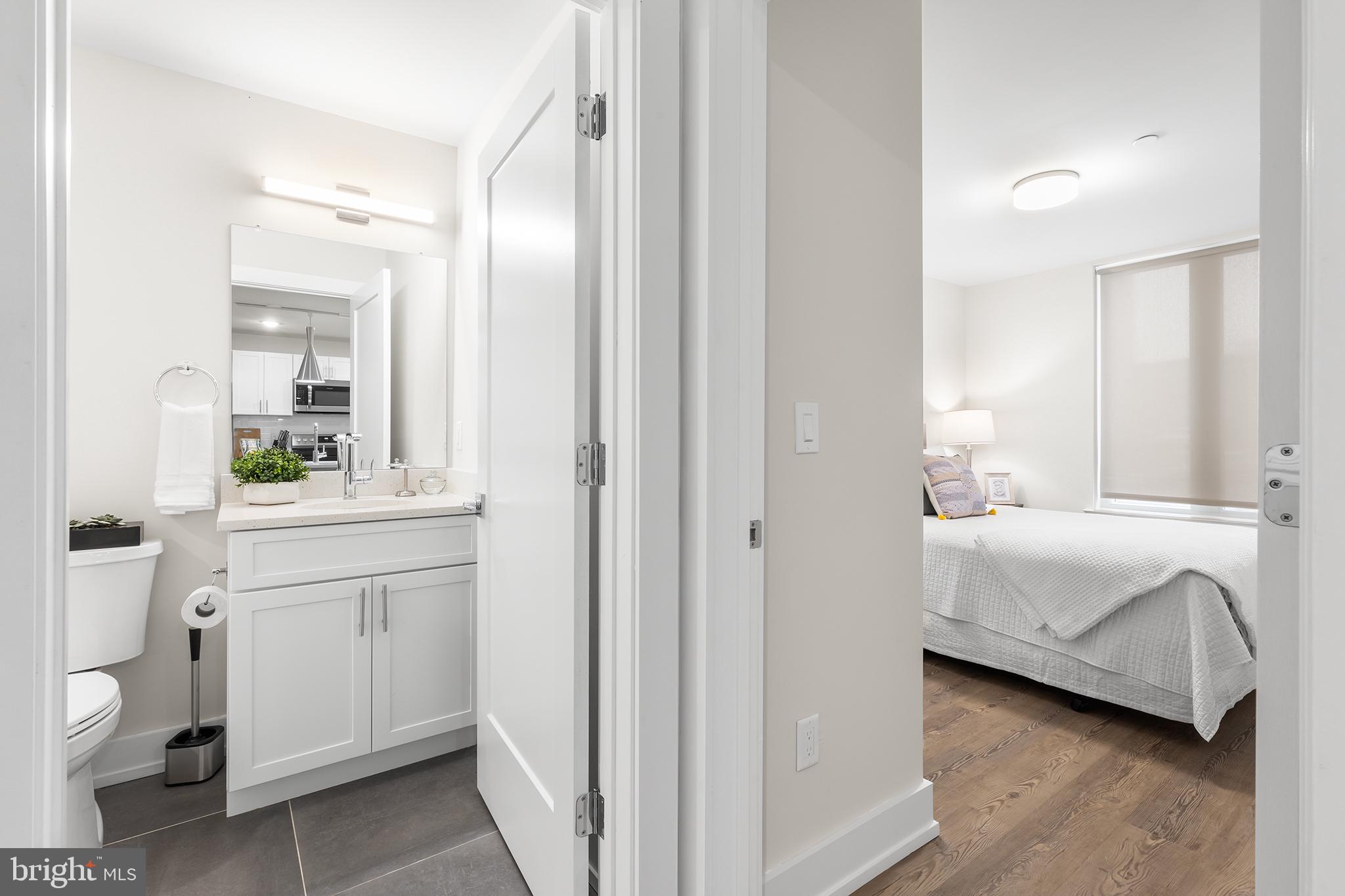 214 Vine Street, Unit 104 Philadelphia, PA 19106 - Photo 15 of 35 a en suite bathroom with a double vanity sink and a mirror