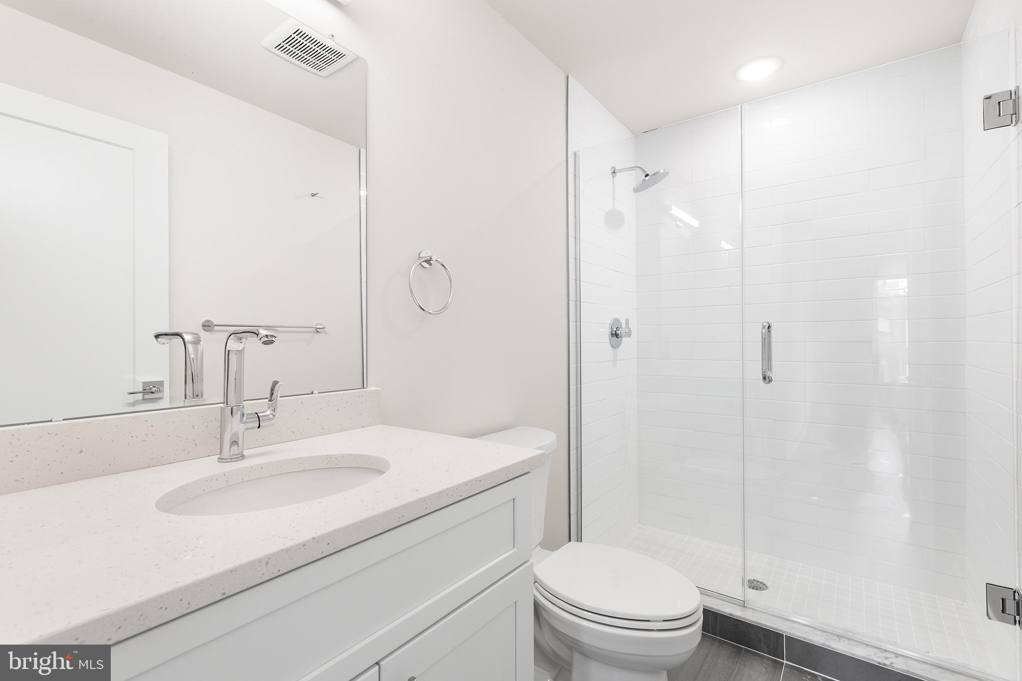 214 Vine Street, Unit 104 Philadelphia, PA 19106 - Photo 31 of 35 a bathroom with a sink toilet and shower