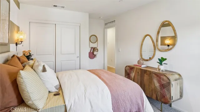 a bedroom with bed and a chandelier