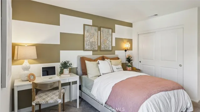 a bedroom with a bed and a night stand