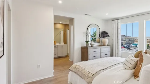 a bedroom with a bed and a mirror