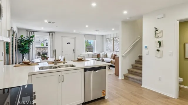 a kitchen with sink and mirror