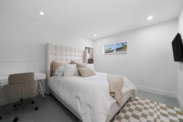 a bedroom with a bed and a chair