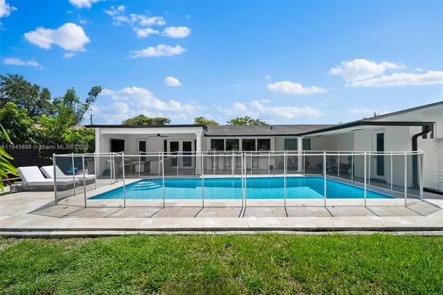 a view of a house with backyard porch and sitting area